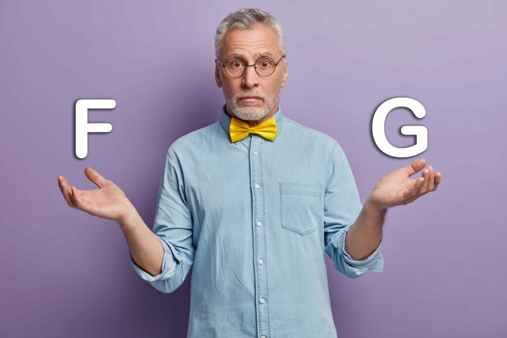 Senior holding letters F and G representing a choice between Medicare Plan F or G