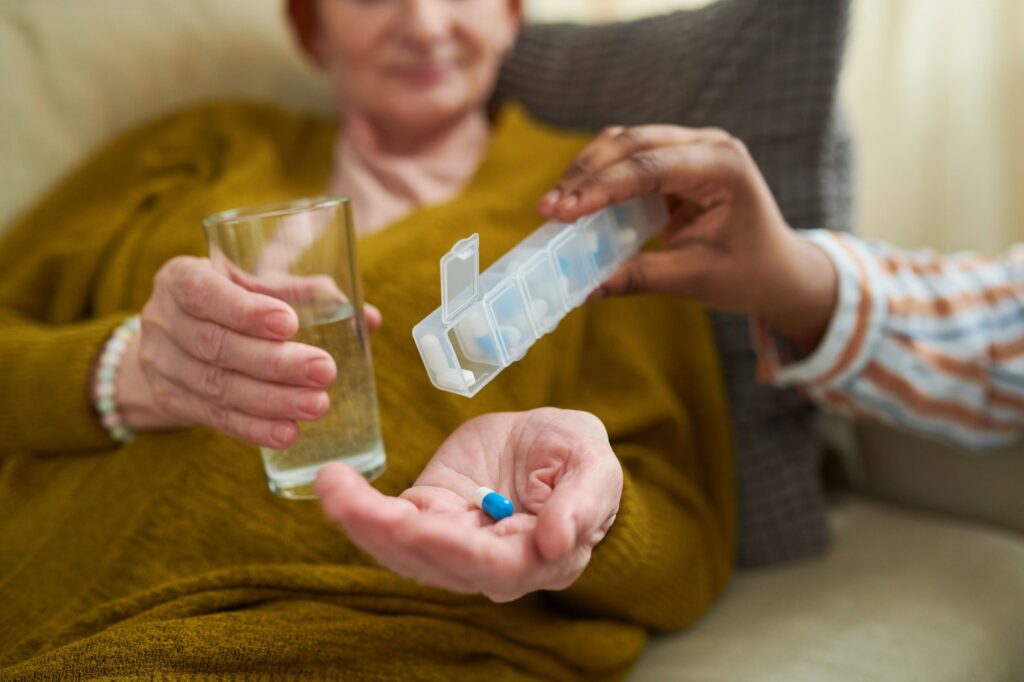 Senior woman taking prescription medications with Medicare Part D Plan