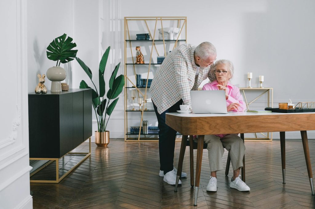Senior couple discussing Medicare enrollment paperwork at home