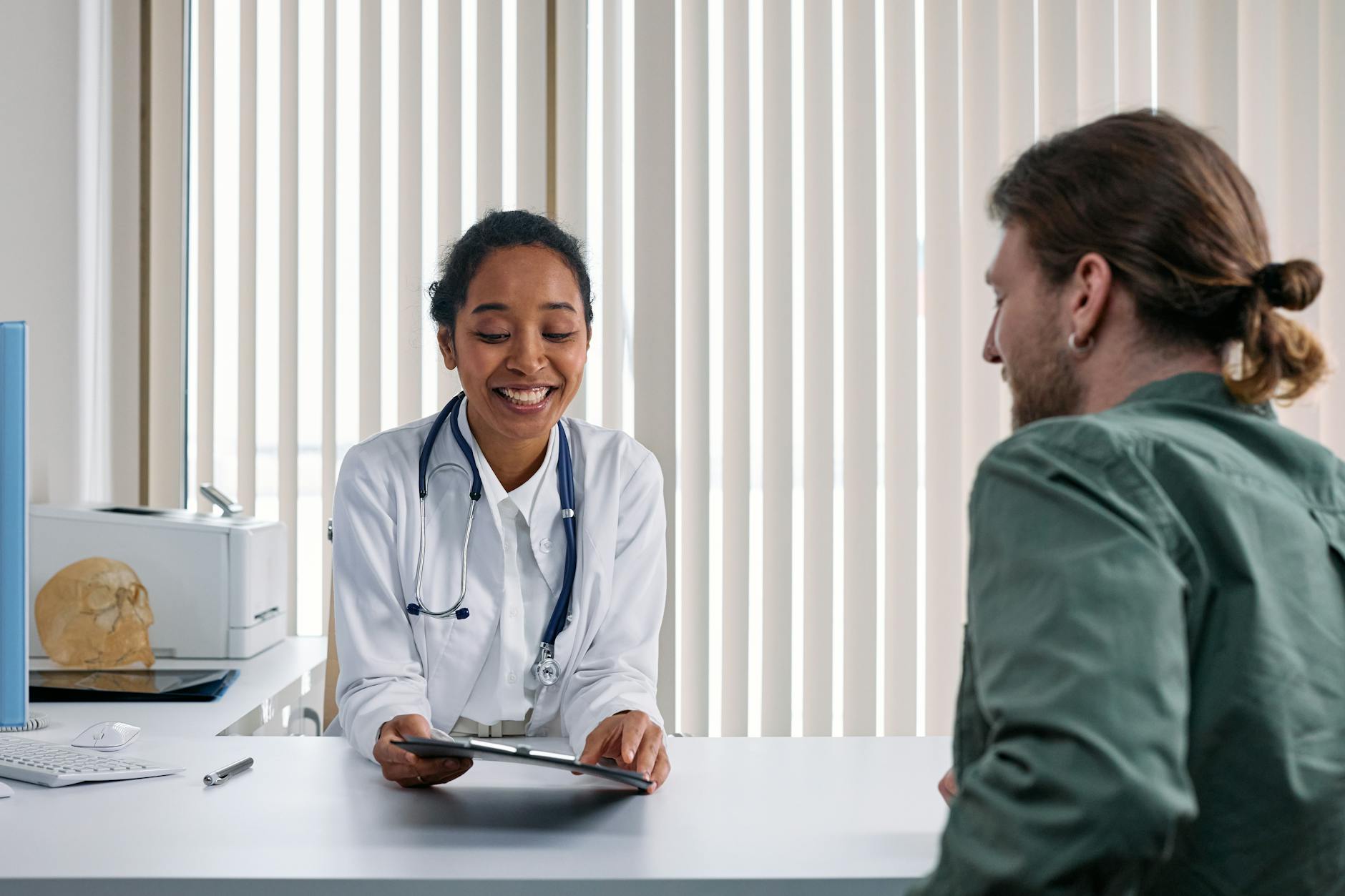 Doctor and patient reviewing health insurance options in a Houston-area clinic