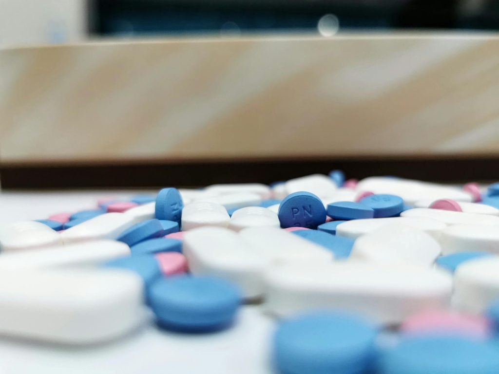 Assorted prescription pills representing the Medicare Part D out-of-pocket cap on covered medications