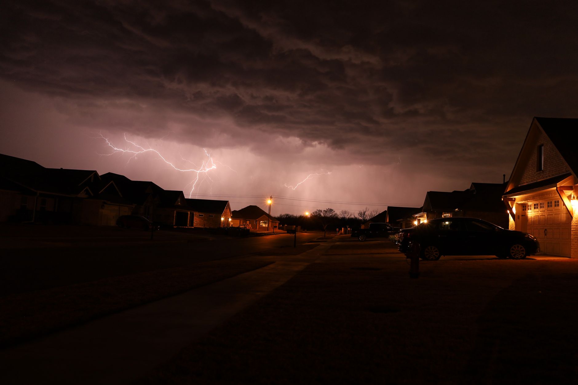 Houston resident reviewing insurance paperwork at home as a storm approaches during hurricane season