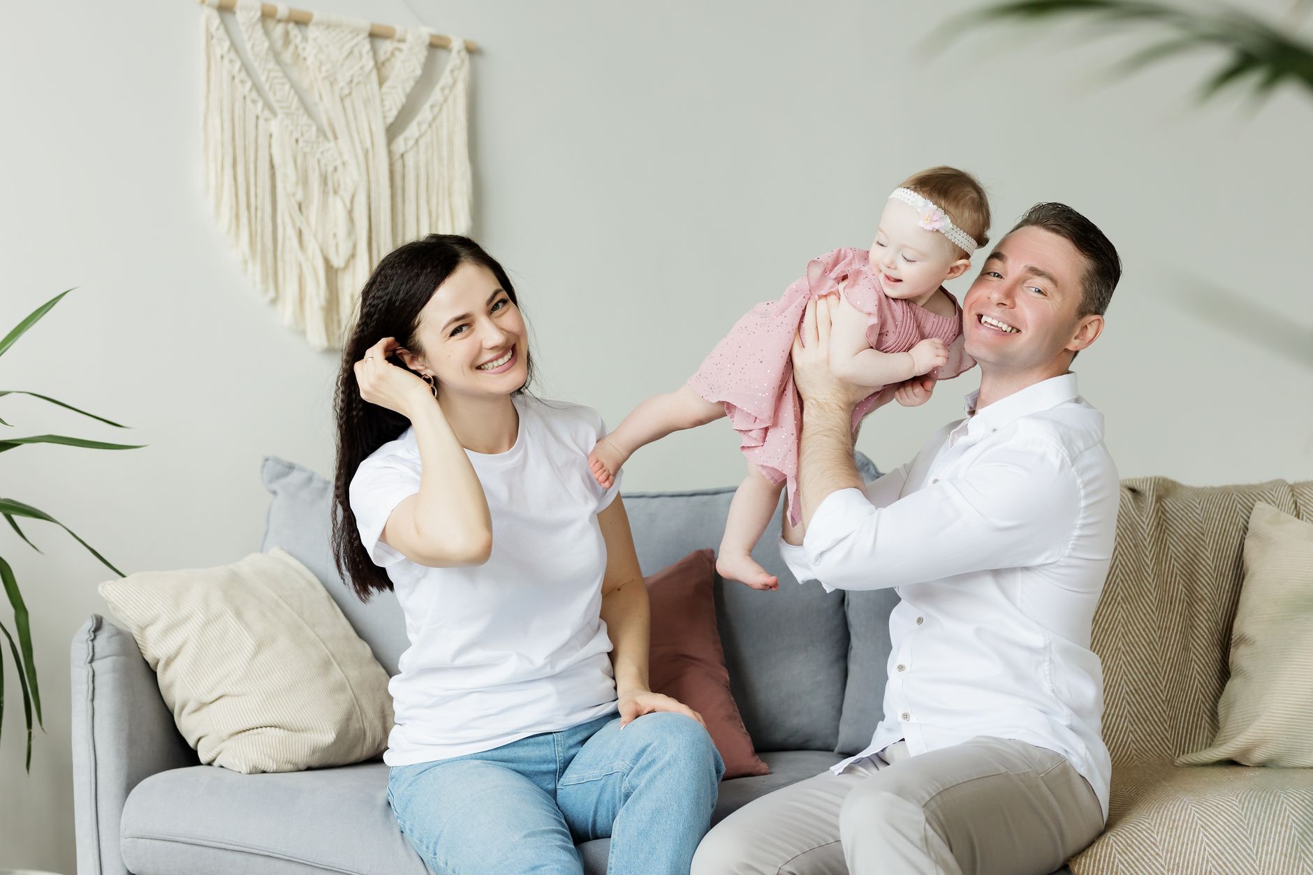 Houston parents at home with their infant after adding the baby to a health plan